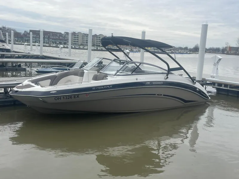 Slide: The Image of 2020 Yamaha Boats 242 Limited S docked on a calm lake. - 25