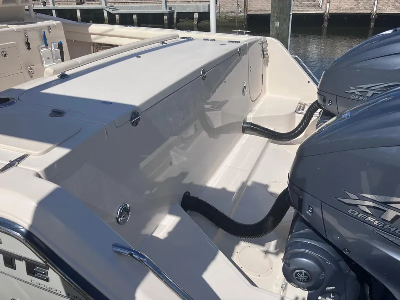 Slide: The Image of 2020 Grady-White Canyon 336 boat with dual outboard engines at a dock. - 14