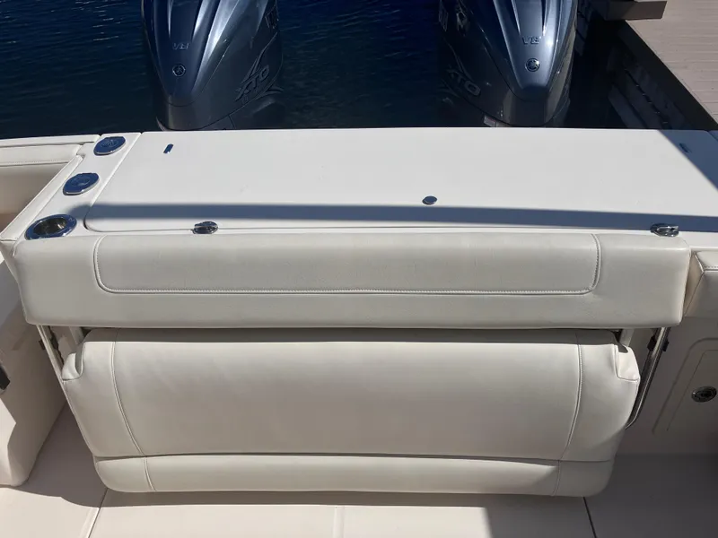 Slide: The Image of 2020 Grady-White Canyon 336 boat with dual outboard engines and cushioned seating. - 18