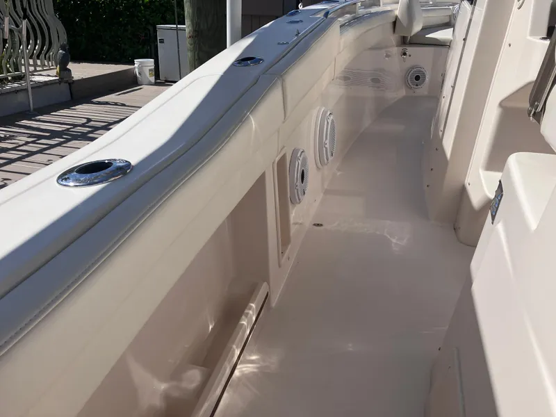 Slide: The Image of 2020 Grady-White Canyon 336 boat interior, featuring sleek white deck and seating area. - 23