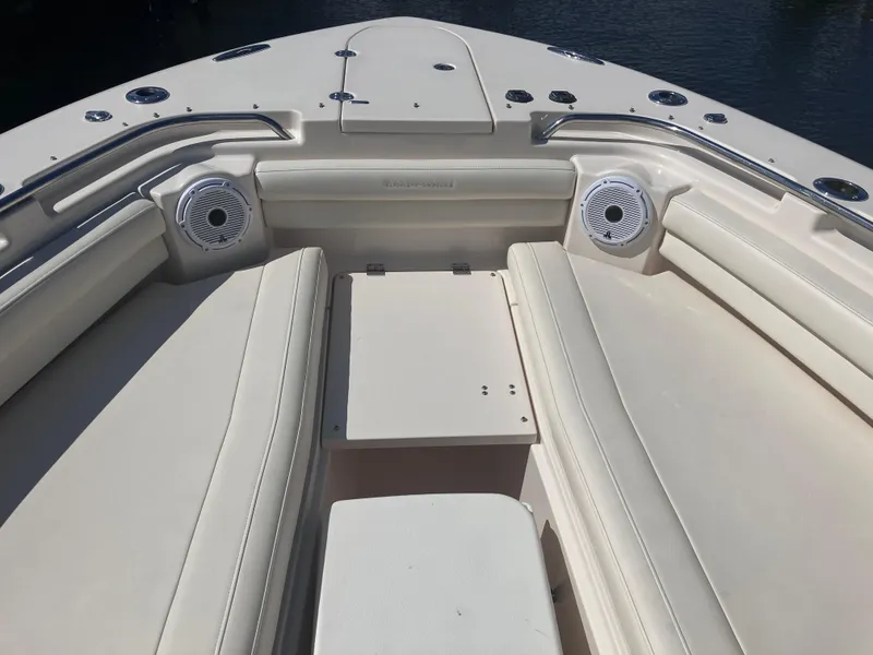 Slide: The Image of 2020 Grady-White Canyon 336 boat interior with cushioned seating and speakers. - 27