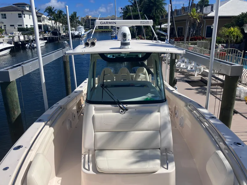 Slide: The Image of 2020 Grady-White Canyon 336 boat docked in a marina, featuring a Garmin radar system. - 33