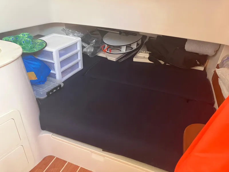 Slide: The Image of 2020 Grady-White Canyon 336 cabin storage area with organized compartments and supplies. - 37