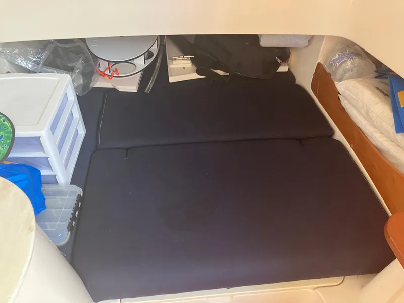 Slide: The Image of 2020 Grady-White Canyon 336 cabin interior with storage and bedding. - 40