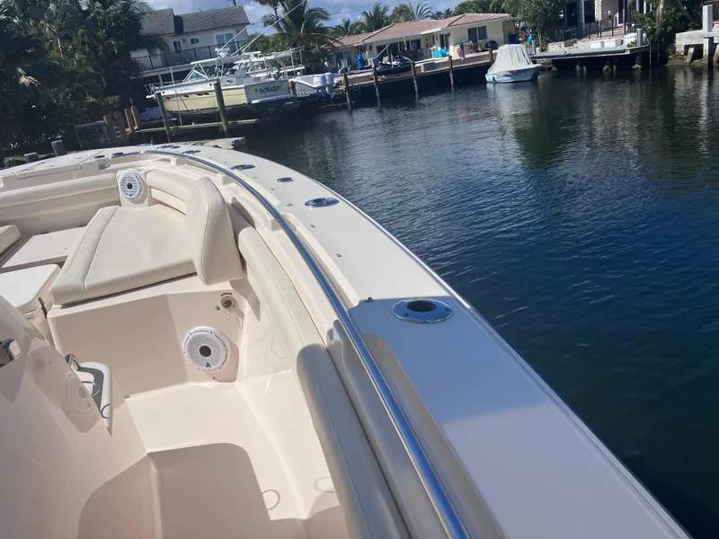 Slide: The Image of 2020 Grady-White Canyon 336 boat docked by a serene waterfront. - 48