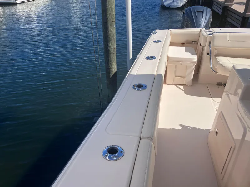 Slide: The Image of 2020 Grady-White Canyon 336 boat docked, showcasing spacious deck and seating area. - 49