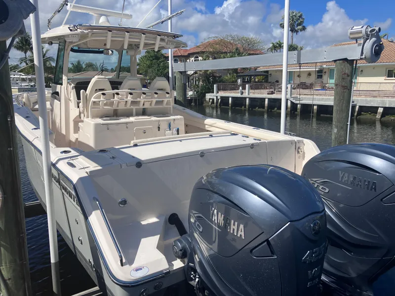Slide: The Image of 2020 Grady-White Canyon 336 boat with Yamaha engines docked by waterfront homes. - 6