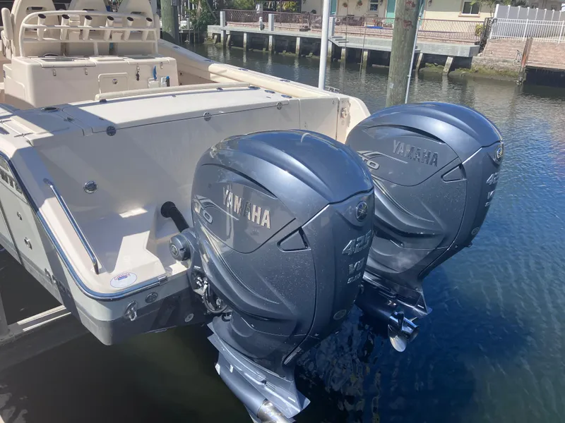 Slide: The Image of 2020 Grady-White Canyon 336 boat with dual Yamaha outboard engines docked by the water. - 7