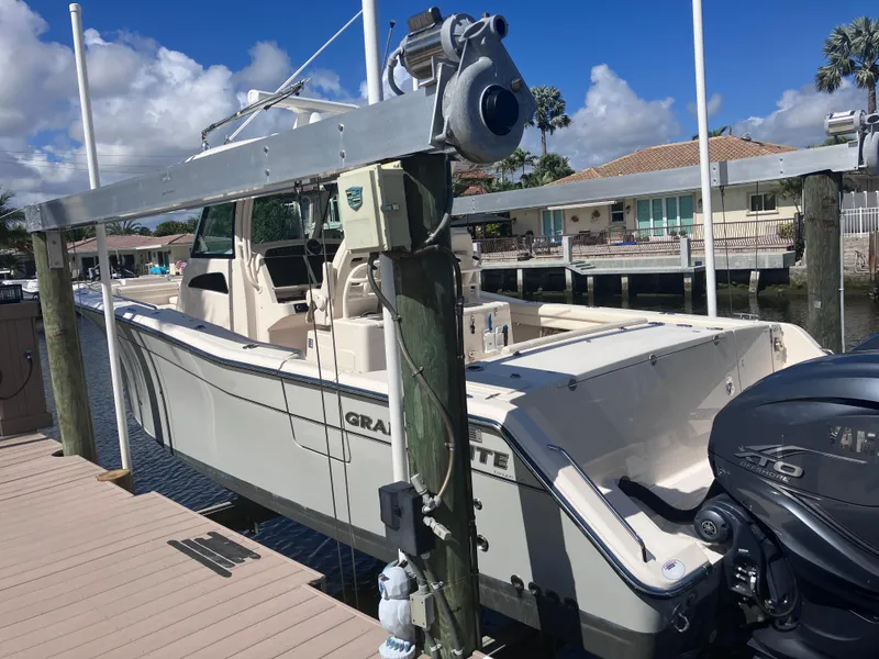 Slide: The Image of 2020 Grady-White Canyon 336 boat docked, featuring powerful outboard engines. - 8