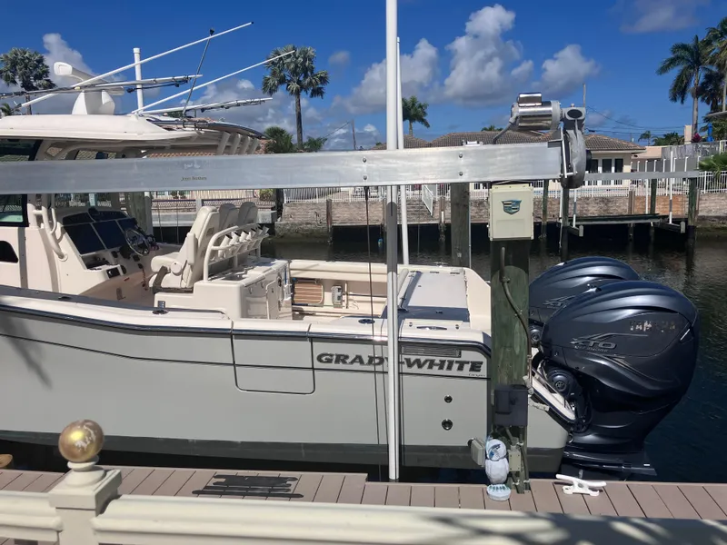 Slide: The Image of 2020 Grady-White Canyon 336 boat docked with twin outboard engines. - 9