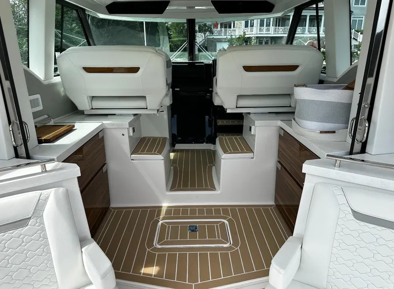 Slide: The Image of 2024 Tiara Yachts 43 LE interior with modern seating and wood flooring. - 11