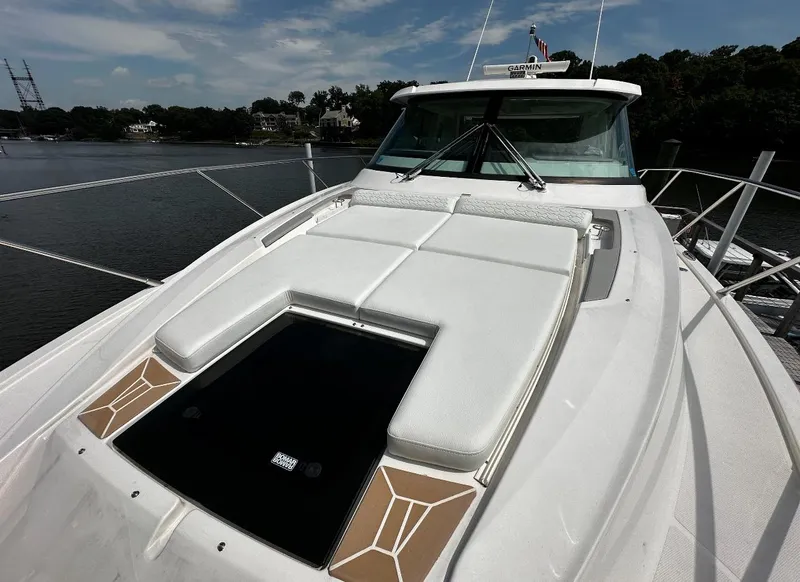 Slide: The Image of 2024 Tiara Yachts 43 LE luxury yacht with sunbathing deck on calm waters. - 13