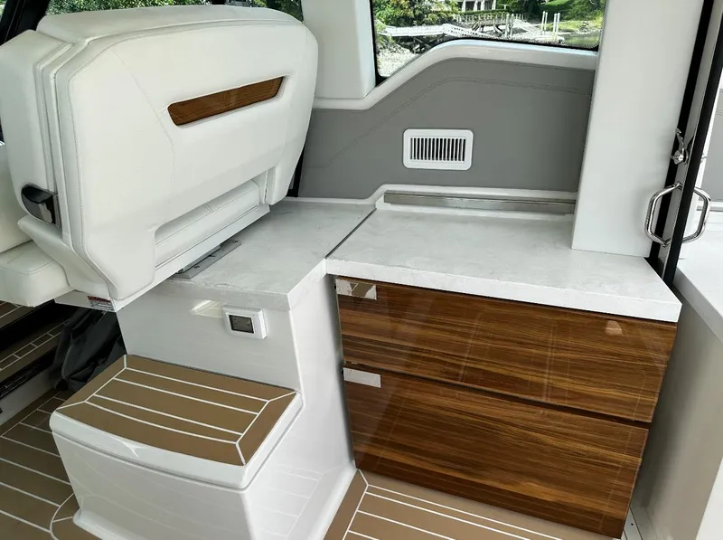 Slide: The Image of 2024 Tiara Yachts 43 LE interior with sleek seating and wooden cabinetry. - 15
