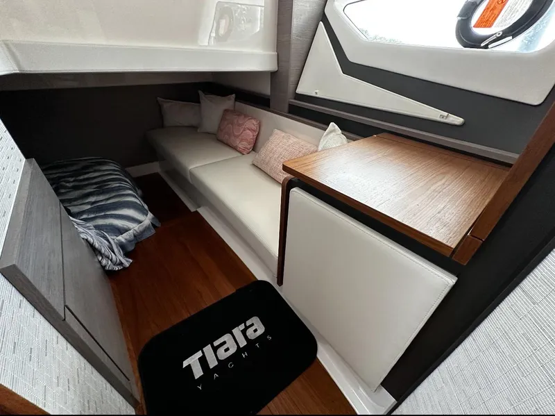 Slide: The Image of 2024 Tiara Yachts 43 LE interior cabin with seating and wooden accents. - 22