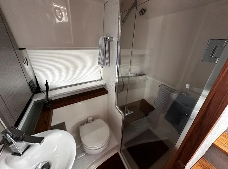 Slide: The Image of 2024 Tiara Yachts 43 LE bathroom with modern fixtures and glass shower enclosure. - 24