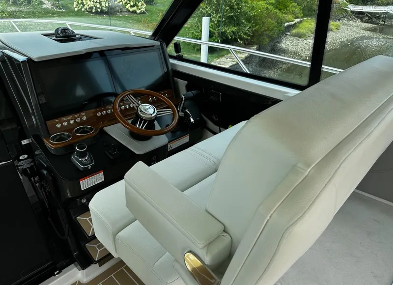 Slide: The Image of 2024 Tiara Yachts 43 LE helm with luxurious seating and advanced controls. - 4