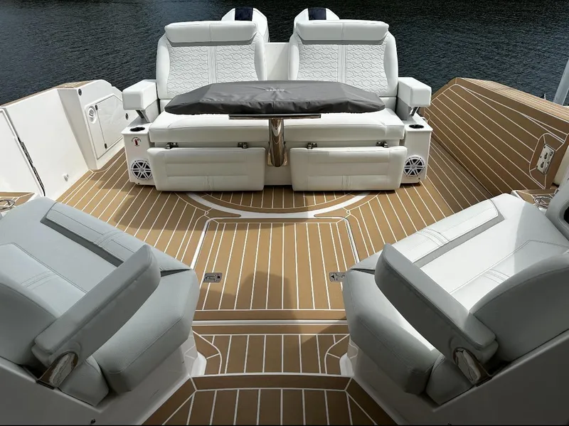 Slide: The Image of 2024 Tiara Yachts 43 LE interior with luxurious seating and elegant wood flooring. - 7