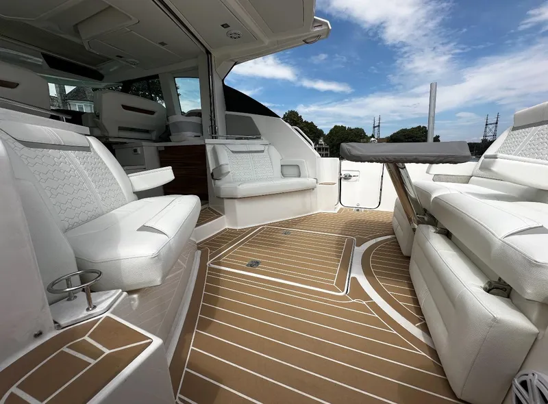 Slide: The Image of 2024 Tiara Yachts 43 LE interior with luxurious white seating and sleek design. - 9