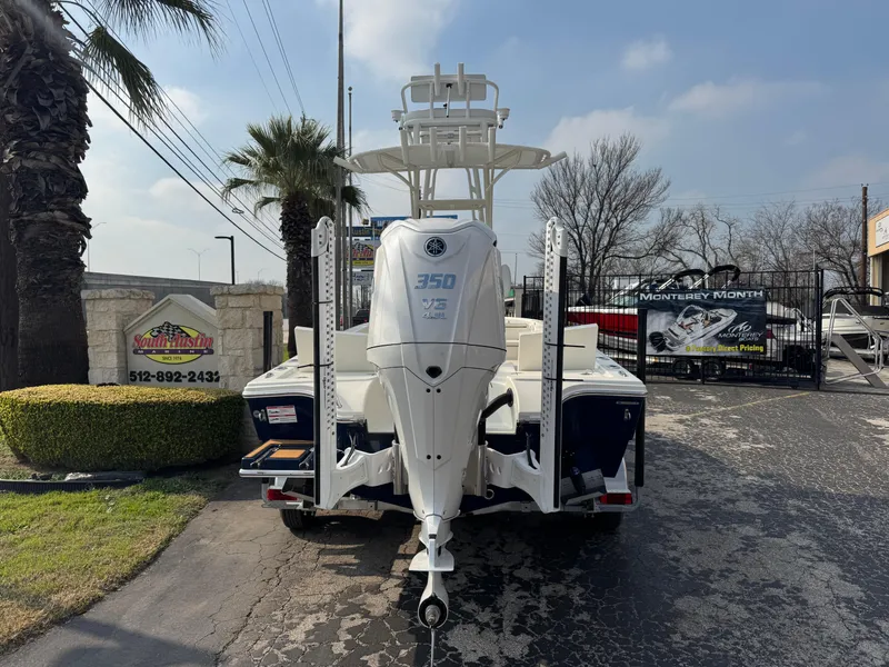 Slide: The Image of 2025 Pathfinder 2500 Hybrid boat with Yamaha 350 engine, parked outdoors near palm trees. - 1