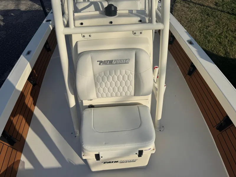 Slide: The Image of 2025 Pathfinder 2500 Hybrid boat interior with white seating and storage. - 14