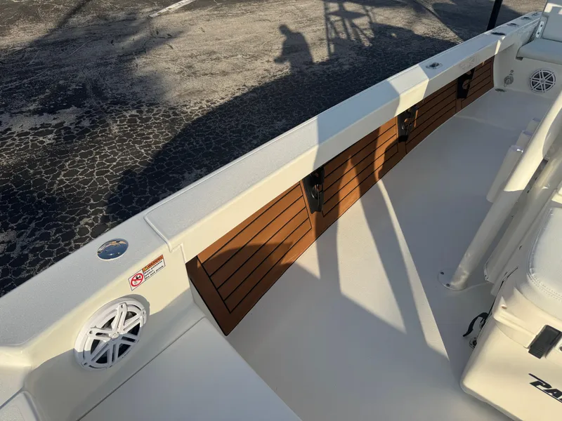 Slide: The Image of 2025 Pathfinder 2500 Hybrid boat interior with wood accents and speaker. - 15