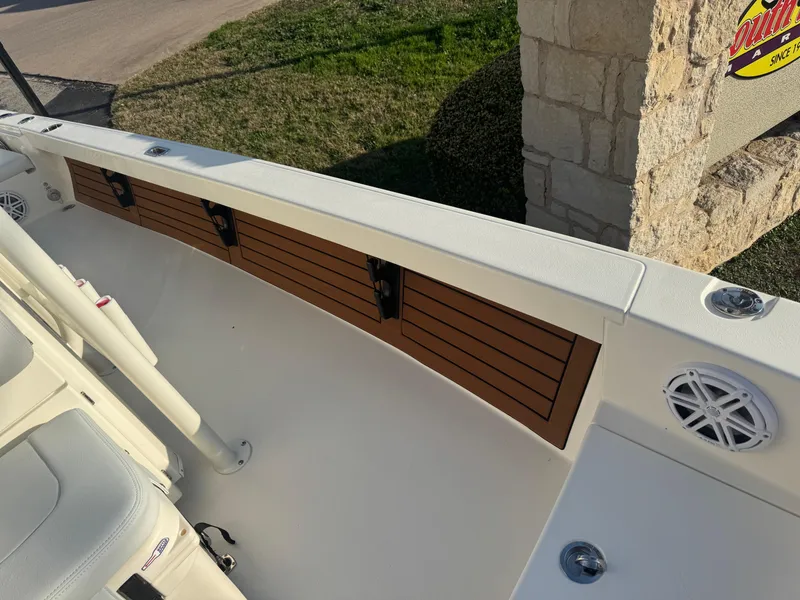 Slide: The Image of 2025 Pathfinder 2500 Hybrid boat interior with wood paneling and speaker. - 16