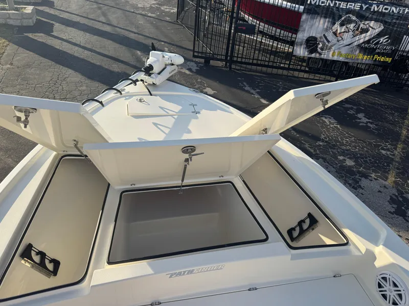 Slide: The Image of 2025 Pathfinder 2500 Hybrid boat with open storage compartments on deck. - 25