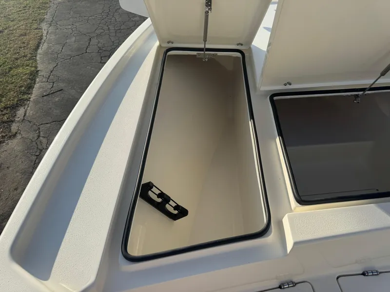 Slide: The Image of Open storage compartments on a 2025 Pathfinder 2500 Hybrid boat deck. - 26