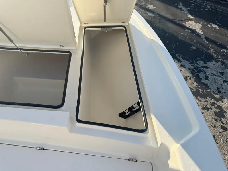 Slide: The Image of Open storage compartments on a 2025 Pathfinder 2500 Hybrid boat deck. - 27