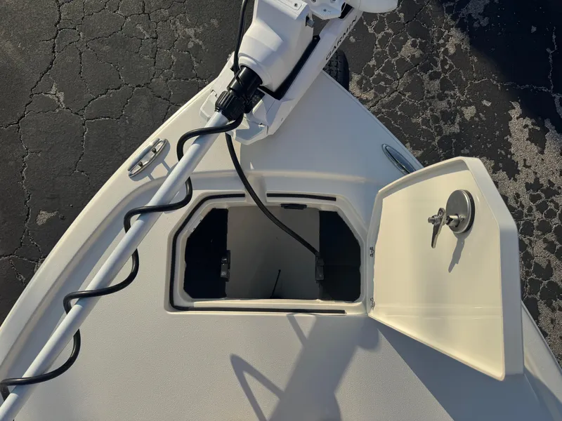 Slide: The Image of Bow of 2025 Pathfinder 2500 Hybrid boat with open storage compartment. - 28