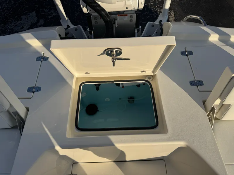 Slide: The Image of 2025 Pathfinder 2500 Hybrid boat with open storage compartment on deck. - 37