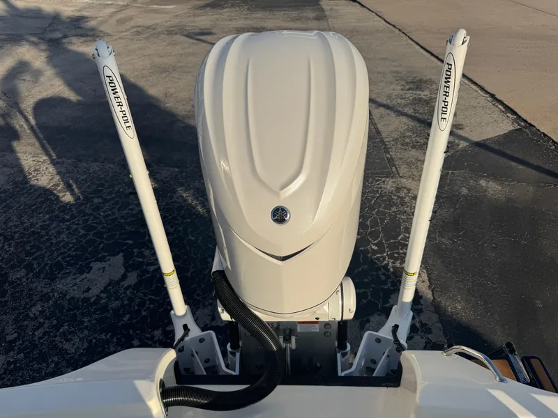 Slide: The Image of 2025 Pathfinder 2500 Hybrid boat engine with Power-Pole anchors on a textured surface. - 38