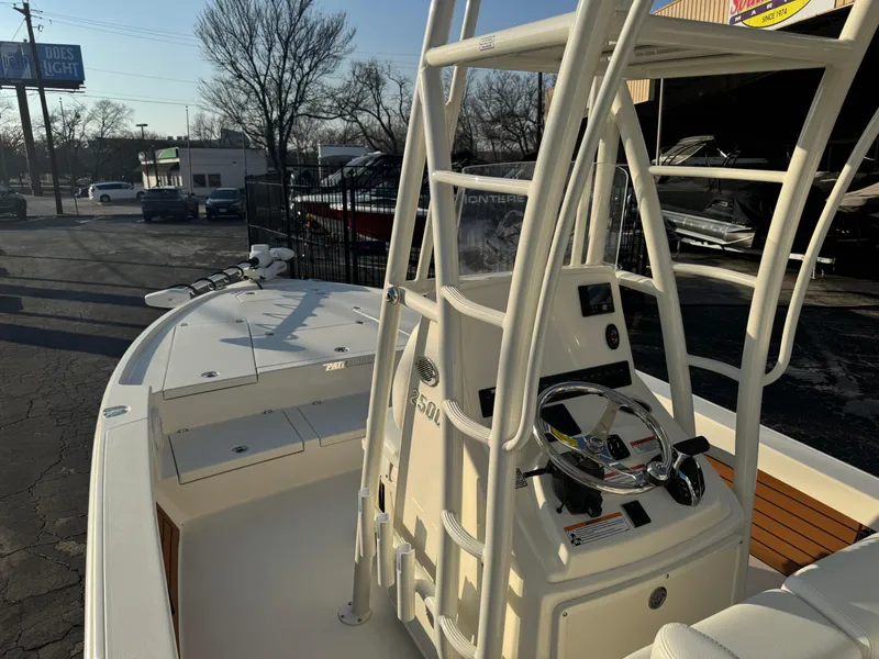 Slide: The Image of 2025 Pathfinder 2500 Hybrid boat with sleek console and steering wheel, parked outdoors. - 40