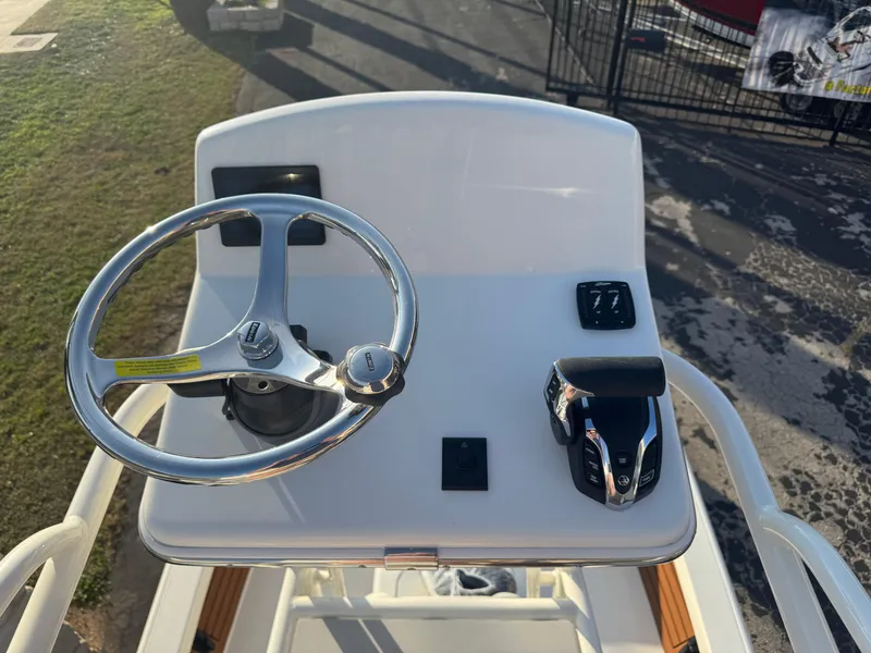 Slide: The Image of 2025 Pathfinder 2500 Hybrid boat helm with steering wheel and controls. - 43