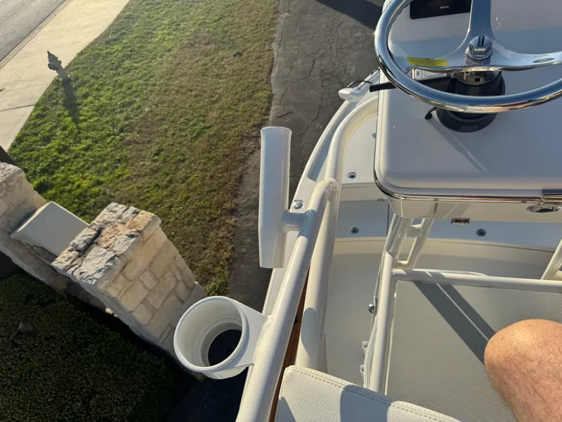 Slide: The Image of Pathfinder 2500 Hybrid boat helm, 2025 model, with steering wheel and cup holder, viewed from above. - 44