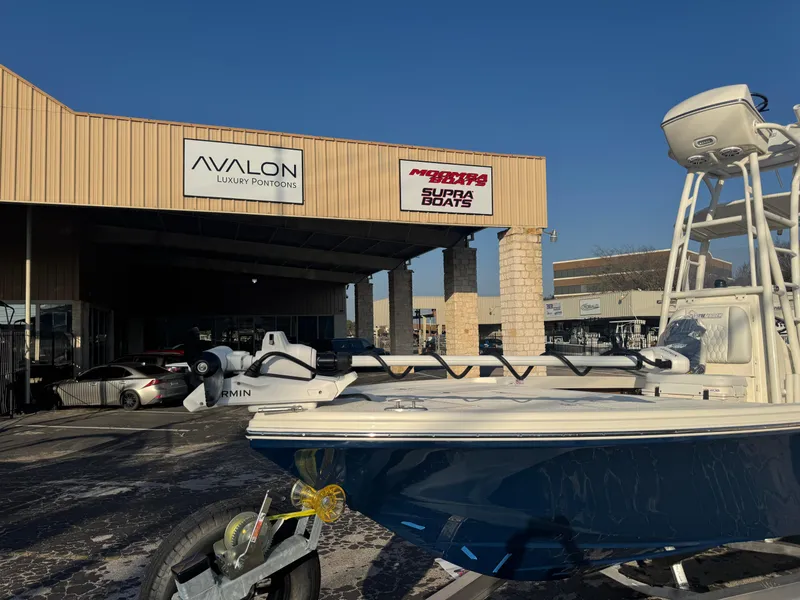 Slide: The Image of 2025 Pathfinder 2500 Hybrid boat at dealership with Avalon and Supra Boats signage. - 48