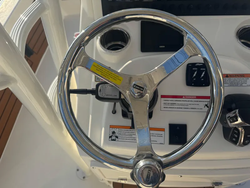 Slide: The Image of Steering wheel of 2025 Pathfinder 2500 Hybrid boat, featuring modern controls and sleek design. - 7