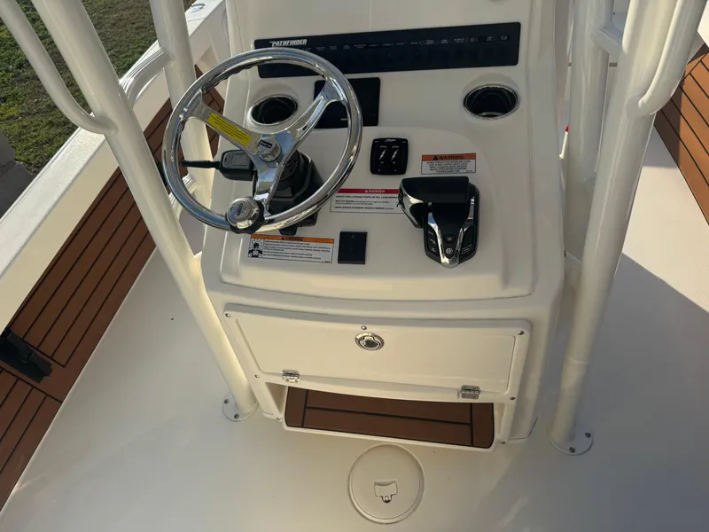 Slide: The Image of 2025 Pathfinder 2500 Hybrid boat console with steering wheel and controls. - 9