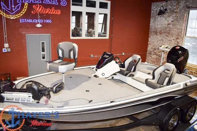 Slide: The Image of 2025 Nitro Z18 Pro fishing boat in showroom, featuring modern seating and equipment. - 12