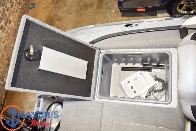 Slide: The Image of Open storage compartment in a 2025 Nitro Z18 Pro boat, featuring interior accessories. - 13