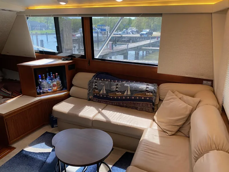 Slide: The Image of Interior of 1990 Viking 45 Convertible yacht with cozy seating and bar area. - 10
