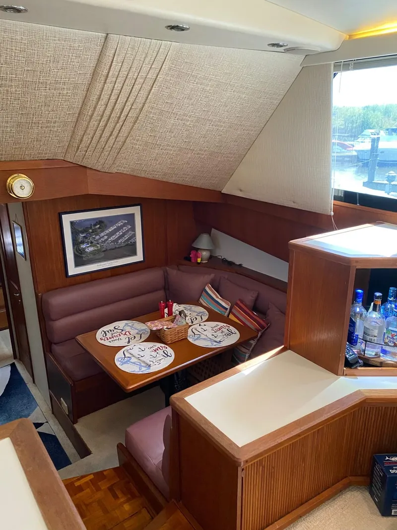 Slide: The Image of Interior of 1990 Viking 45 Convertible yacht with cozy dining area and decor. - 13