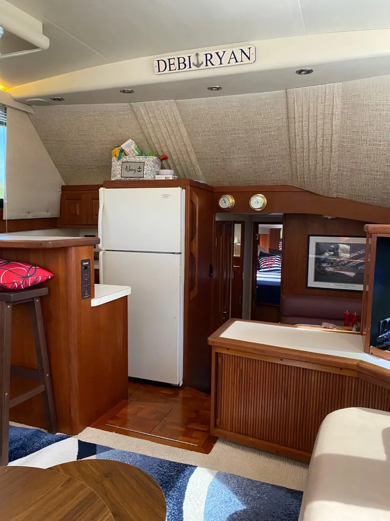 Slide: The Image of Interior of a 1990 Viking 45 Convertible yacht with kitchen and seating area. - 15