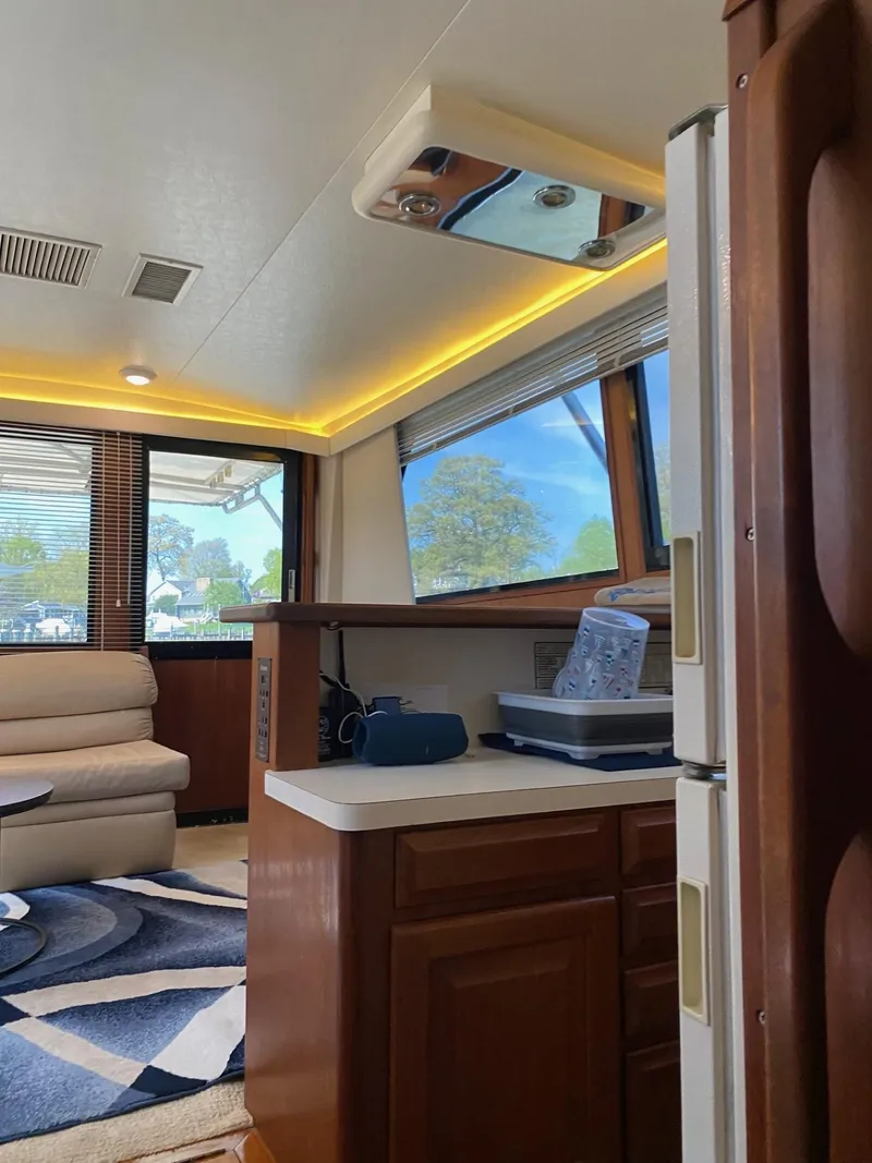 Slide: The Image of Interior of 1990 Viking 45 Convertible yacht with modern furnishings and large windows. - 18