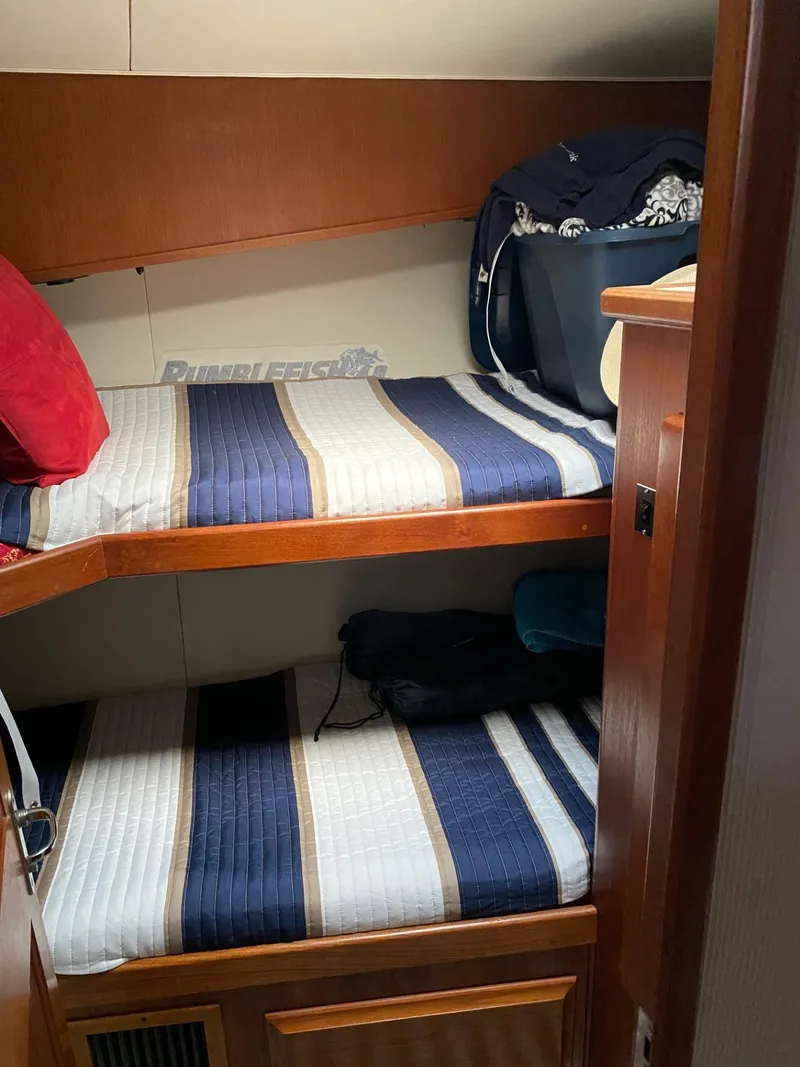 Slide: The Image of Bunk beds in 1990 Viking 45 Convertible boat cabin with striped bedding. - 20