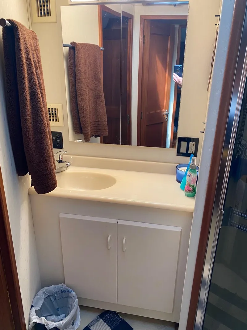 Slide: The Image of Bathroom interior of 1990 Viking 45 Convertible yacht with sink and mirror. - 21