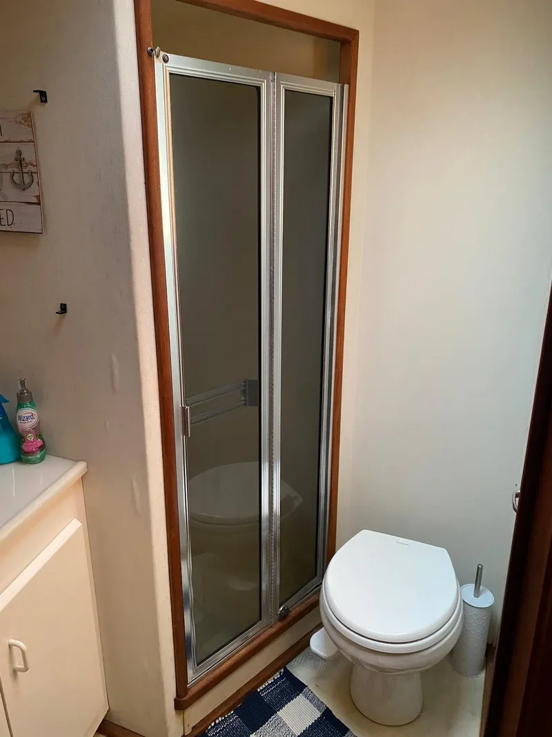 Slide: The Image of Compact bathroom in a 1990 Viking 45 Convertible boat with shower and toilet. - 22