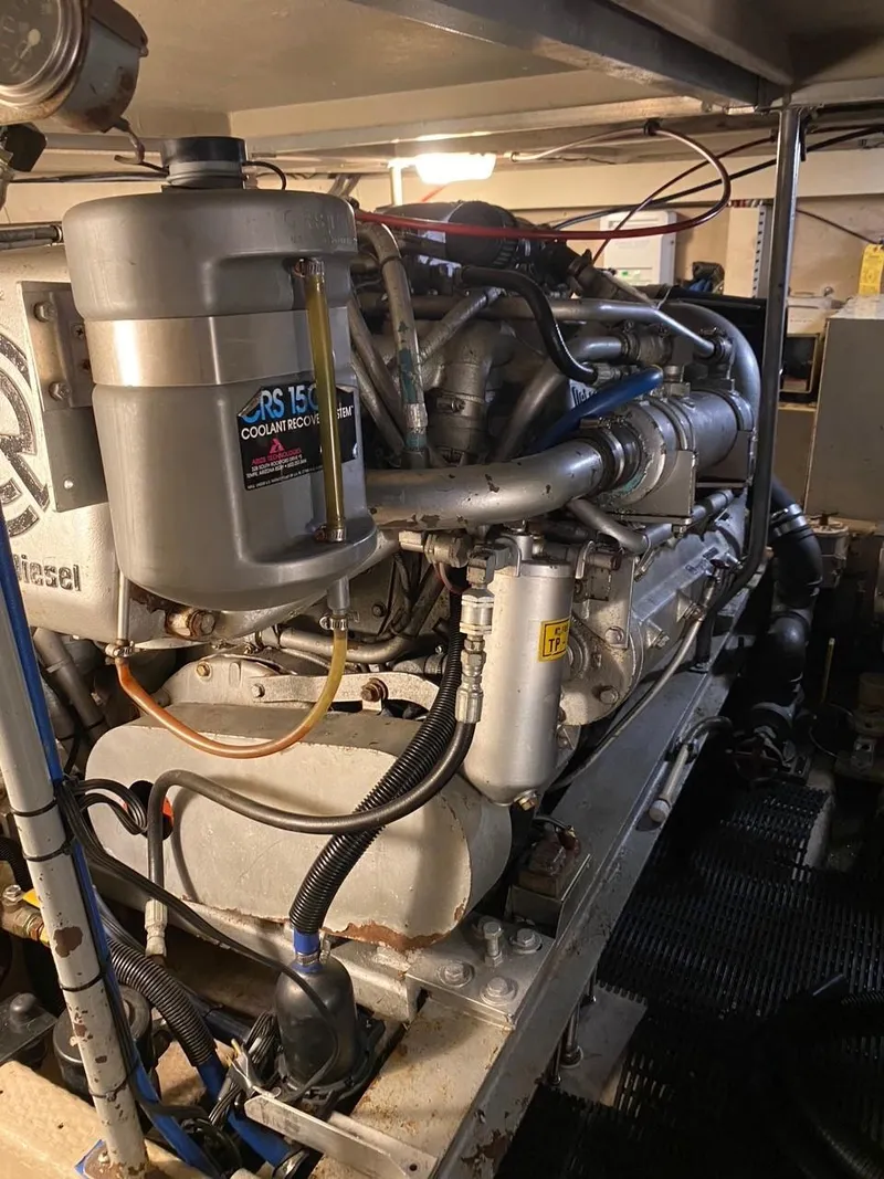 Slide: The Image of Engine room of a 1990 Viking 45 Convertible boat, showcasing detailed machinery components. - 24