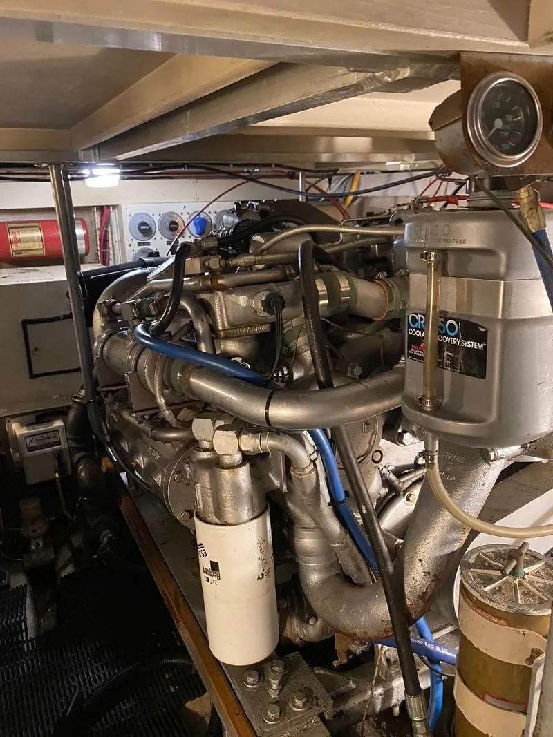 Slide: The Image of Engine room of a 1990 Viking 45 Convertible boat, showcasing detailed machinery and components. - 25