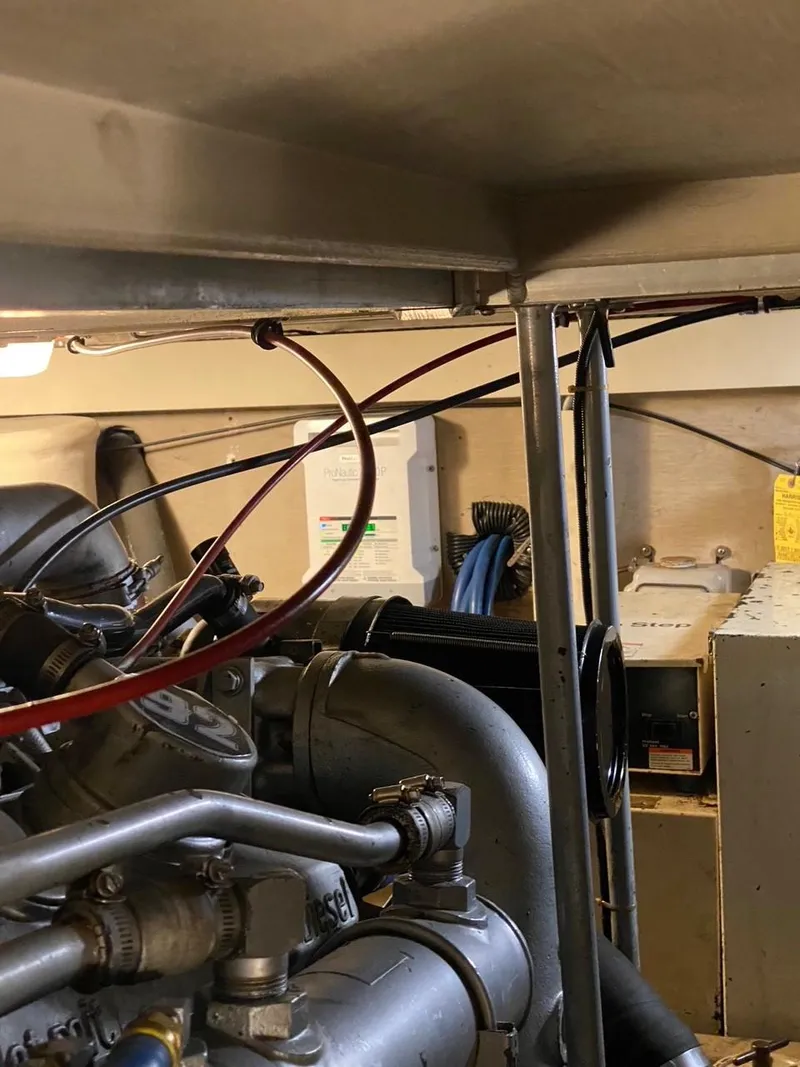 Slide: The Image of Engine room of a 1990 Viking 45 Convertible boat, showcasing mechanical components. - 26